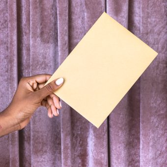 Hand holding an envelope mockup